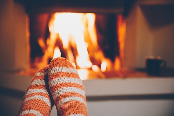 Sitting by a fire.