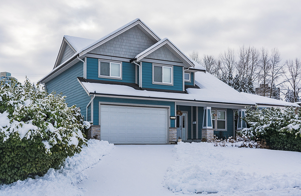 Blue colored home with white trim and gutters.