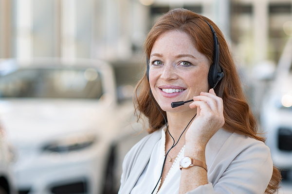 Woman talking on the phone using a headset.