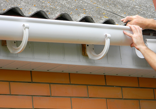 White gutters on a brick building.