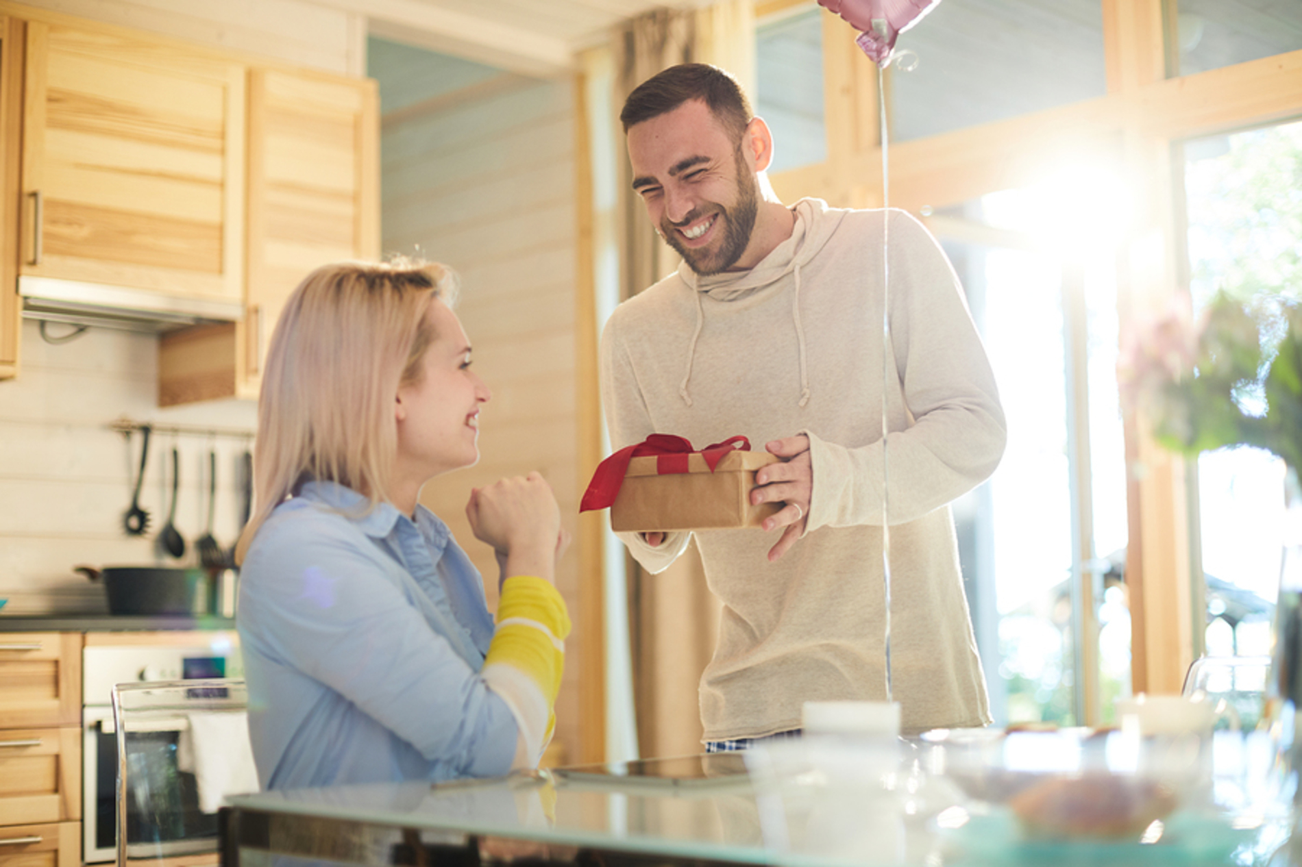 Man giving a gift to his wife.