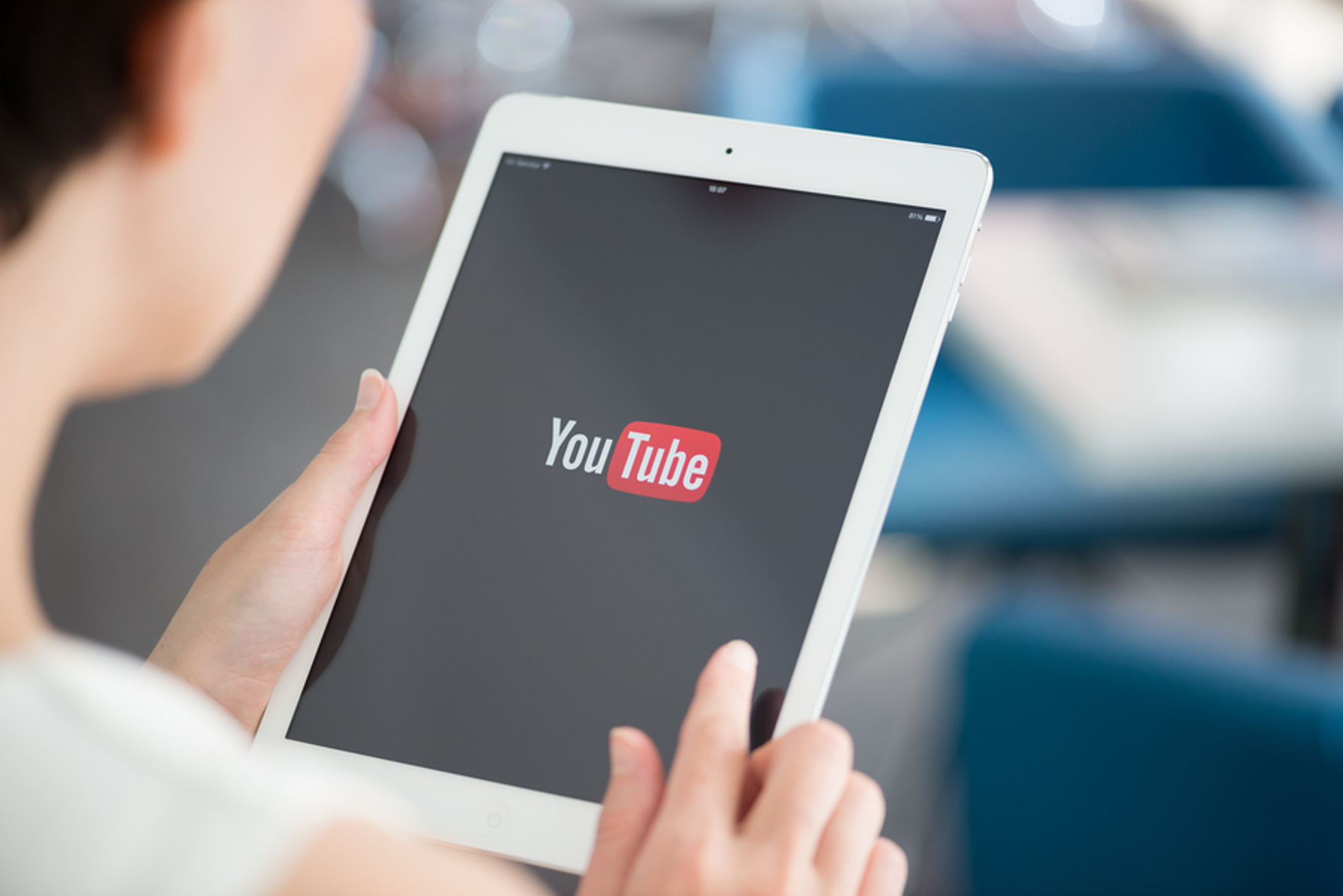 Person looking at YouTube app on their tablet. Person looking at YouTube app on their tablet.