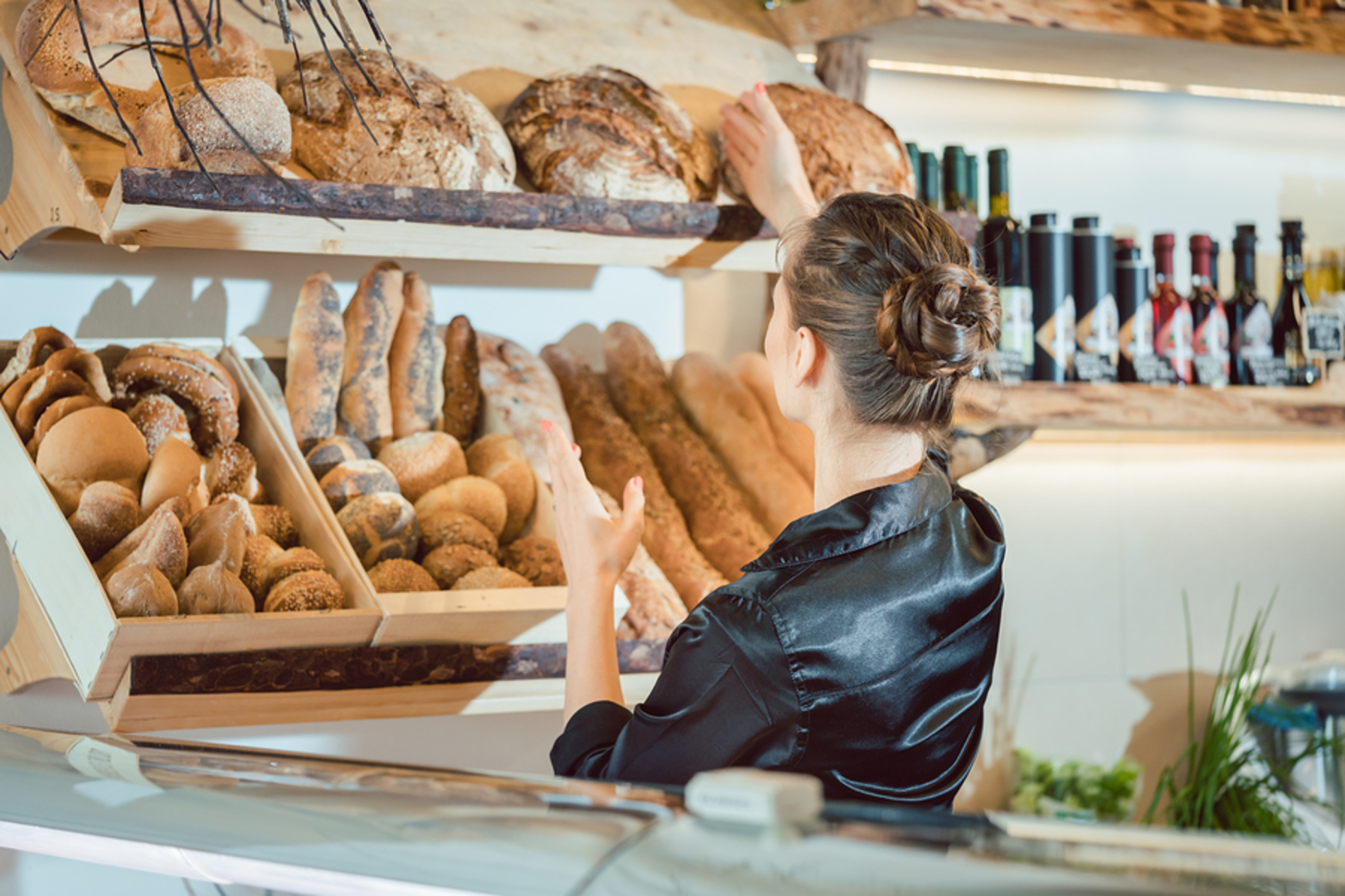 Shop owner stocking fresh bread.