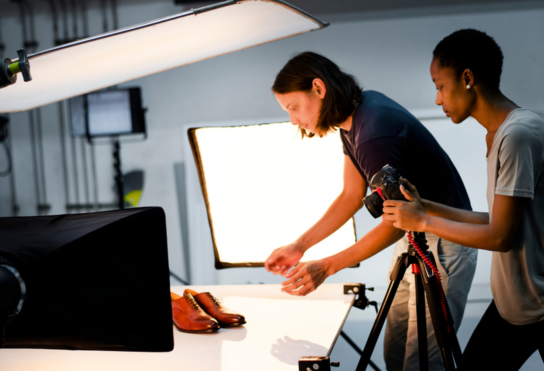 Photographer taking photos of shoes.