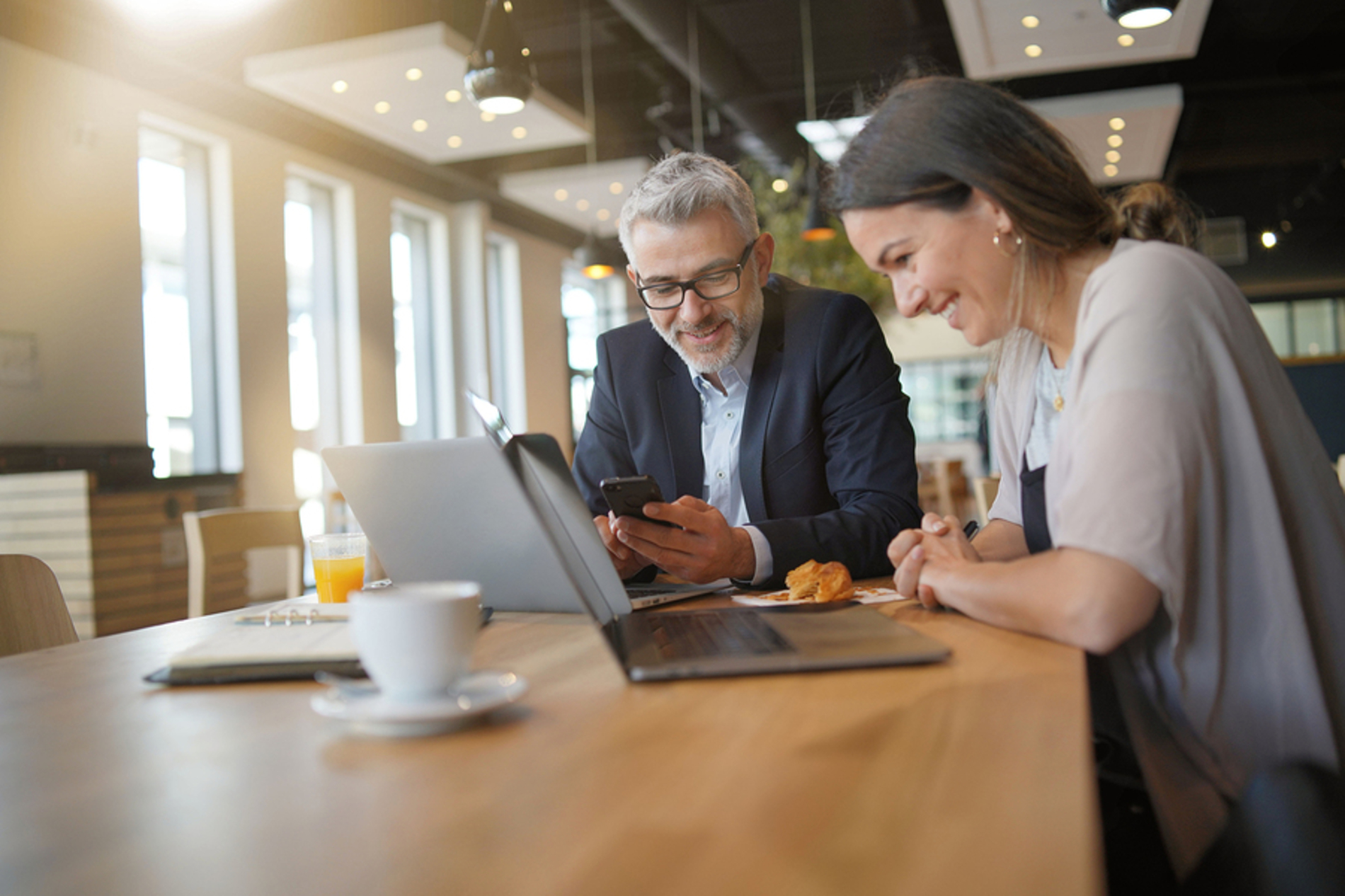 Two people working at a table together.