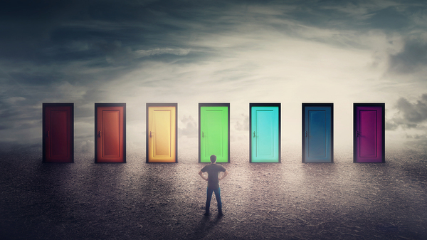 Person standing in front of many doors.