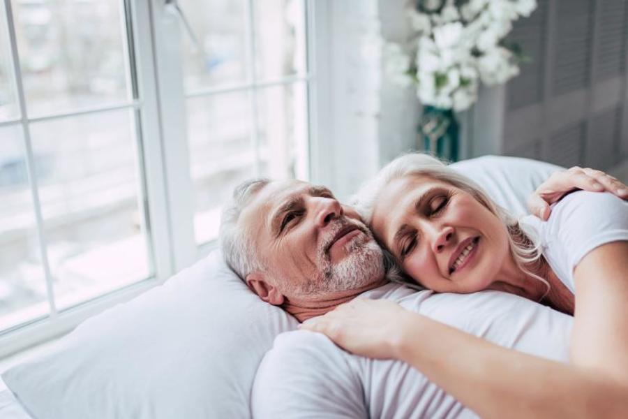 Older couple cuddling.