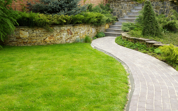 Brick pathway leading to stone stairs.