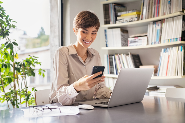 Omnichannel communications image 2 Smiling woman looking at her phone.