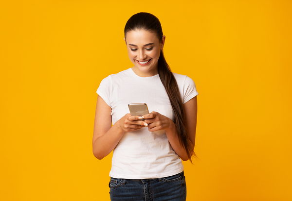 Smiling woman looking at her phone.