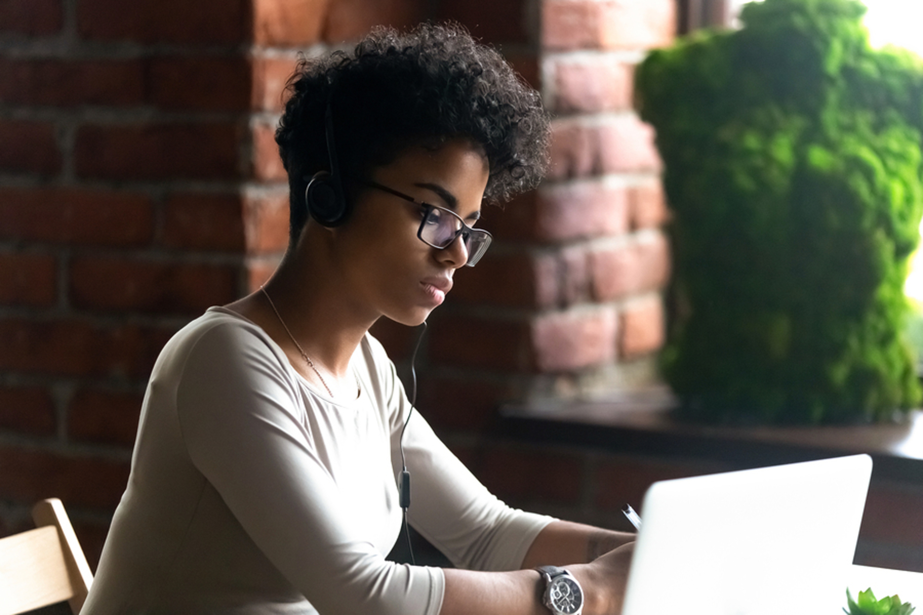 Woman typing on a laptop.