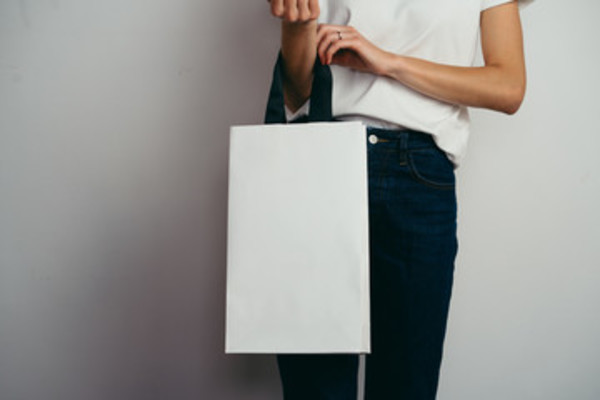 Holding a shopping bag.