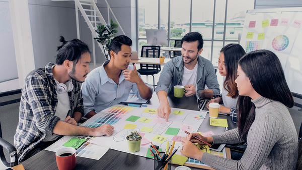 Group of colleagues sitting around a table discussing ideas.