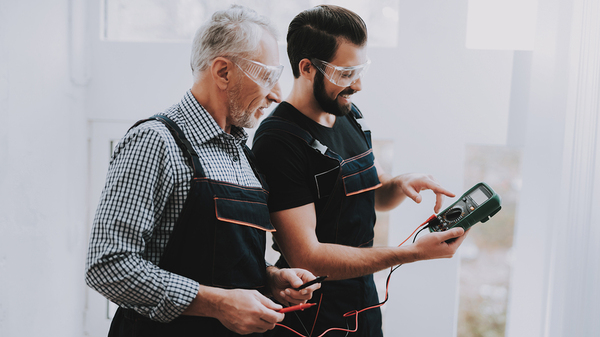 Younger worker seeking advice from an older worker.