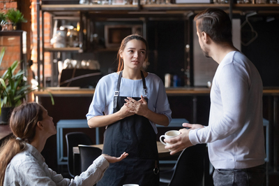 Man order coffee from a cafe worker.