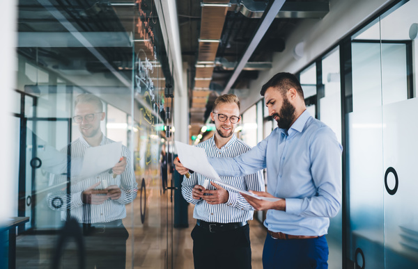 Two colleagues looking at documents together - cybersecurity