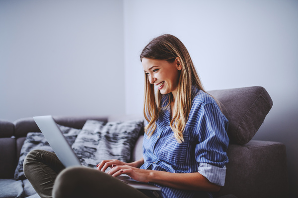 interactive communication - Smiling woman using a laptop.