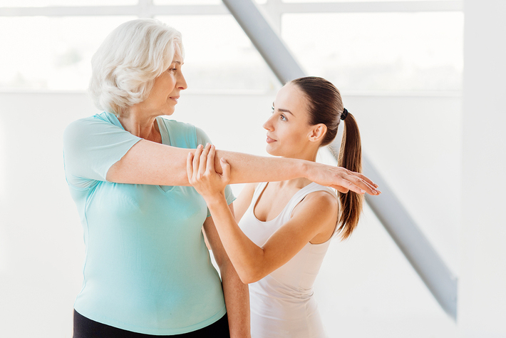 Woman working with a personal trainer.