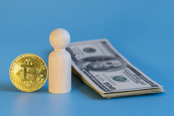 Gold coin with bitcoin symbol, paper money and human figure.