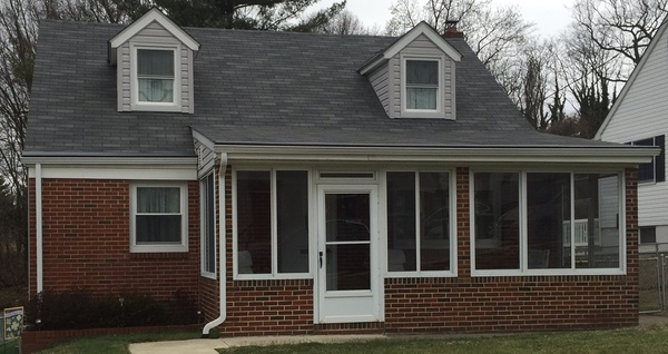 Brick front home with white gutters.