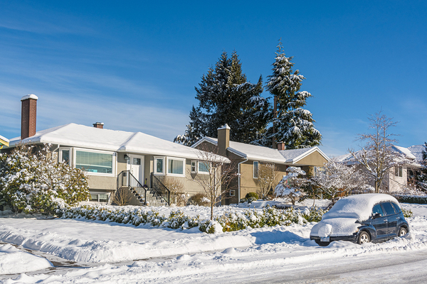 Neighborhood homes covered in snow.