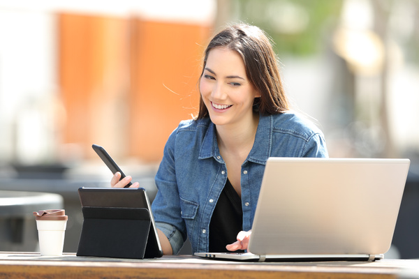 Digital self-service image 1 - Smiling woman looking at her laptop screen.