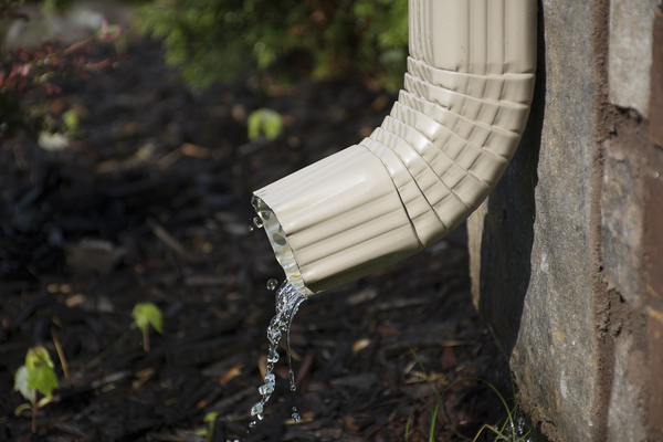 Downspout with water coming out.