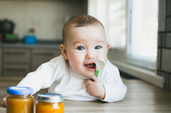 Baby with spoon.