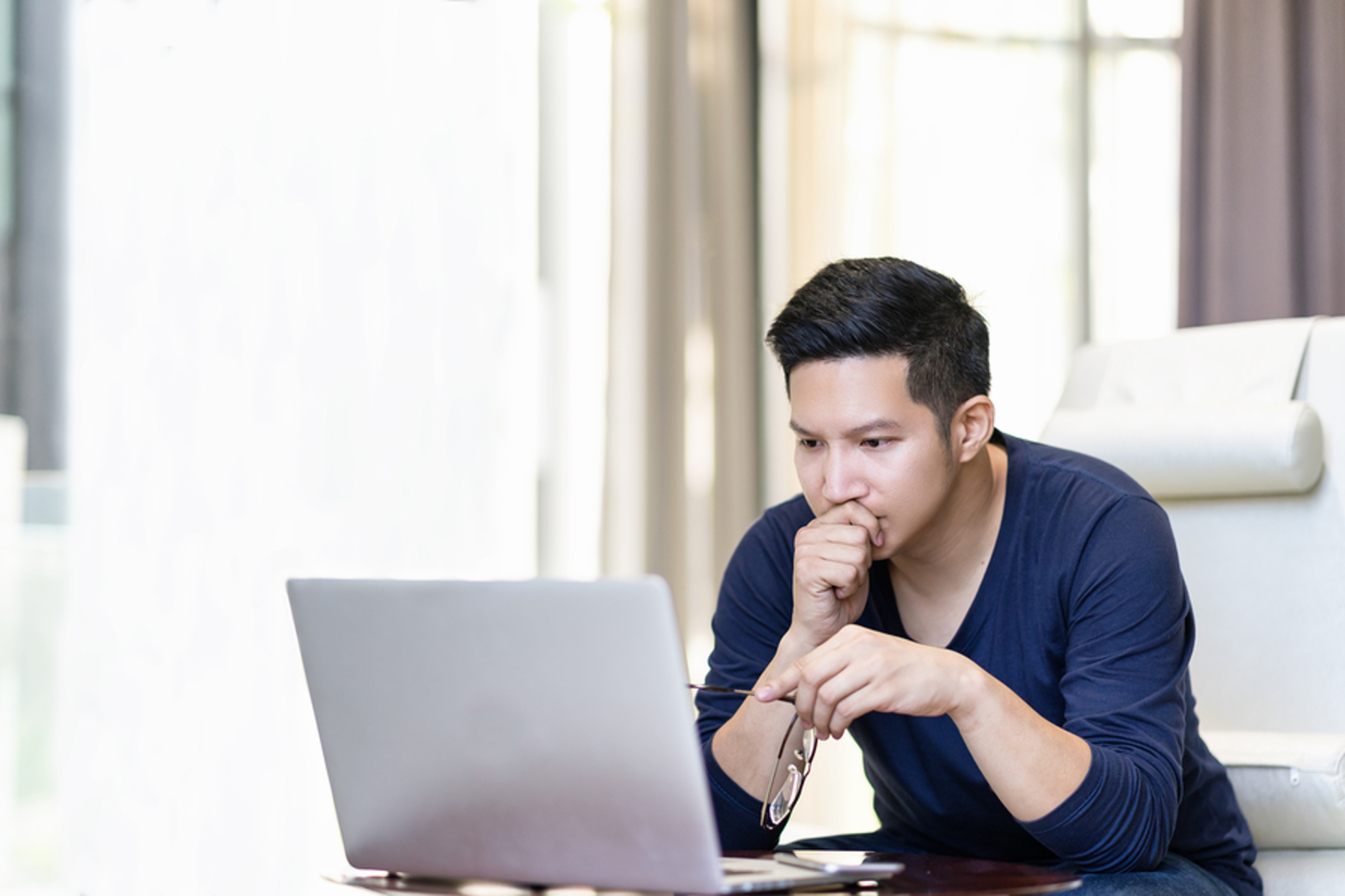 Man looking at a laptop computer screen.