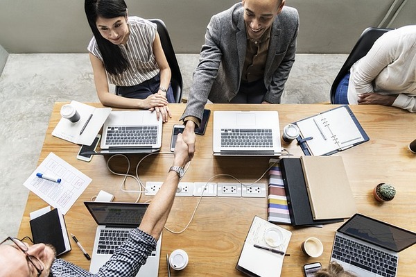 Group of people working around a conference table.