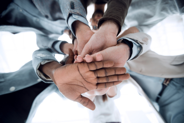 Group of people holding hands.