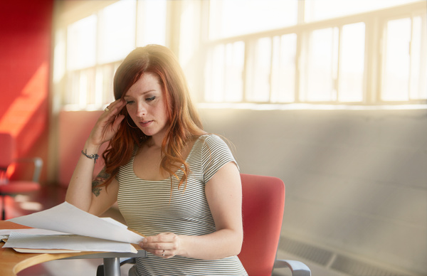 Woman reading documents on Hyperautomation of SAP processes.