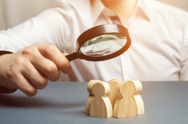 Wooden shaped people in a circle.