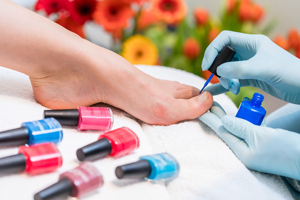 Person getting their toenails painted.