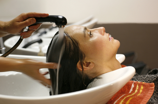 Woman having her hair washed in a beauty salon.