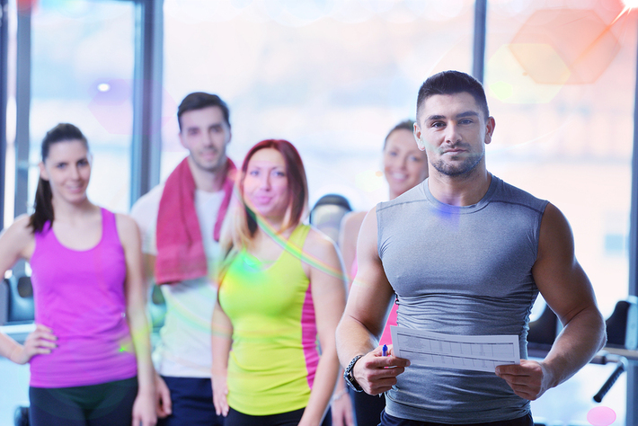 Group of people in fitness clothing smiling.